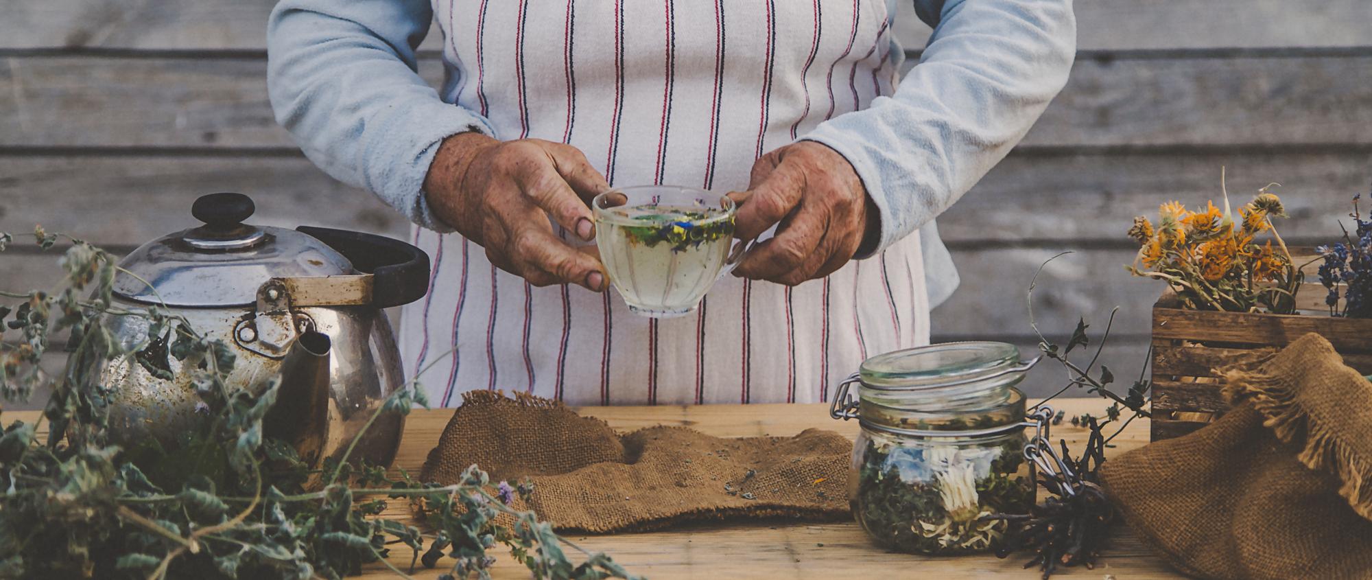 artisan chef arranging herbs in a rustic kitchen